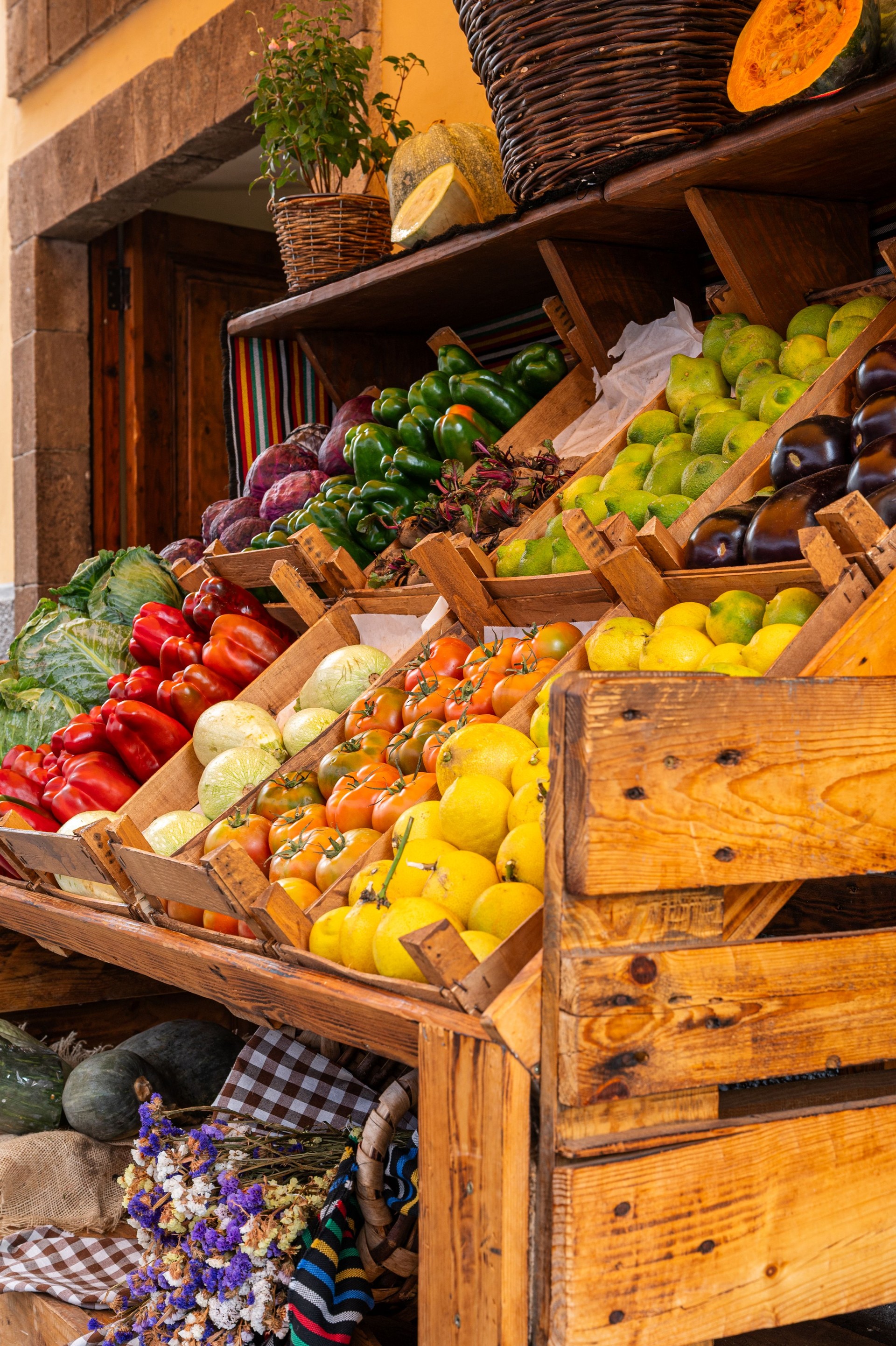 A wooden crate full of fruit and vegetables.
